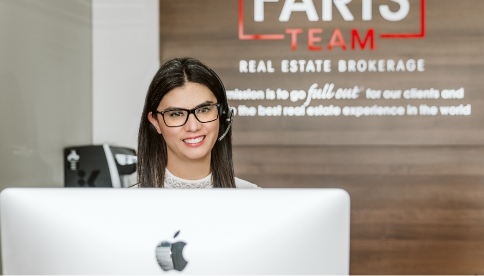 A Faris Team member speaking to a client on the phone using a headset.